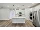 Bright, open kitchen boasts stainless steel appliances, a central island, and stylish pendant lighting at 241 Martin Spring Rd, Lawrenceville, GA 30045