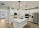 Modern kitchen features stainless steel appliances, white cabinets, and a large island at 241 Martin Spring Rd, Lawrenceville, GA 30045