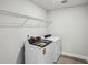 Bright laundry room featuring modern washer and dryer units and ample storage shelving for added convenience at 241 Martin Spring Rd, Lawrenceville, GA 30045
