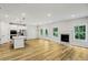Bright and open living space with a modern kitchen, fireplace, and hardwood floors offering a comfortable living area at 241 Martin Spring Rd, Lawrenceville, GA 30045