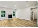 Inviting living room with fireplace, light wood floors, and windows creating a bright and airy space at 241 Martin Spring Rd, Lawrenceville, GA 30045