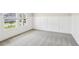 Well-lit room with neutral carpet, crisp white wainscoting, and a large window at 241 Martin Spring Rd, Lawrenceville, GA 30045