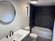 Bathroom featuring new vanity, toilet and shower/tub with dark gray tile at 106 Evergreen Trl, Cartersville, GA 30121