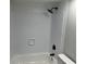 Bathtub and shower with new white tiles and black hardware at 106 Evergreen Trl, Cartersville, GA 30121