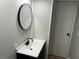 Half bath with new vanity, hardware and round mirror at 106 Evergreen Trl, Cartersville, GA 30121