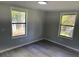 Bedroom with two windows, durable flooring, and neutral paint at 106 Evergreen Trl, Cartersville, GA 30121