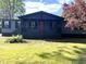 Charming home featuring a covered porch with dark gray siding and a contrasting red front door at 106 Evergreen Trl, Cartersville, GA 30121