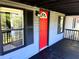 Inviting front porch with bright red door, black shutters and wood flooring at 106 Evergreen Trl, Cartersville, GA 30121