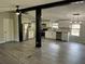 Bright open floor plan featuring stainless steel appliances, a modern light fixture and luxury vinyl plank flooring at 106 Evergreen Trl, Cartersville, GA 30121