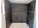 Contemporary shower featuring dark gray tile and modern shower head at 106 Evergreen Trl, Cartersville, GA 30121