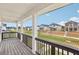 Community view from a covered balcony with wood decking and dark railings; multiple homes are visible at 1270 Firefly Field Trce, Lawrenceville, GA 30045