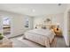 Bright bedroom features a large bed, stylish lamps, and access to a balcony with outdoor views at 1270 Firefly Field Trce, Lawrenceville, GA 30045