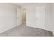 This bedroom features neutral carpeting and paint with two doors for closet or ensuite access at 1270 Firefly Field Trce, Lawrenceville, GA 30045