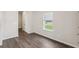 Empty bedroom with laminate flooring and a window overlooking the yard at 1270 Firefly Field Trce, Lawrenceville, GA 30045