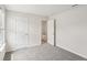 Carpeted bedroom with an open white door and window that brings in natural light at 1270 Firefly Field Trce, Lawrenceville, GA 30045