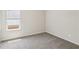 Neutral bedroom featuring gray carpet, a window, and fresh white walls at 1270 Firefly Field Trce, Lawrenceville, GA 30045