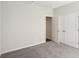 A carpeted bedroom featuring an open closet and an open door at 1270 Firefly Field Trce, Lawrenceville, GA 30045