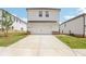 New two-story home with a two-car garage, ample driveway space, and green lawn in a suburban neighborhood at 1270 Firefly Field Trce, Lawrenceville, GA 30045