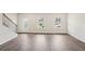 Bright living room featuring laminate floors and natural light from two front windows at 1270 Firefly Field Trce, Lawrenceville, GA 30045