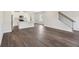 Open-concept living space with laminate floors leading to a modern kitchen at 1270 Firefly Field Trce, Lawrenceville, GA 30045