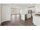 Open-concept living space featuring laminate floors and a modern kitchen at 1270 Firefly Field Trce, Lawrenceville, GA 30045