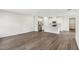 Open-concept living space with laminate floors and a modern kitchen in the background at 1270 Firefly Field Trce, Lawrenceville, GA 30045
