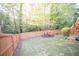 Large backyard with green grass, wooden fence, patio seating, and stairs leading to a deck at 2019 Chelton Se Way, Smyrna, GA 30080