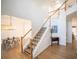 Bright foyer showcasing a staircase with wooden railings and hardwood floors at 2019 Chelton Se Way, Smyrna, GA 30080