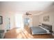 Spacious main bedroom with hardwood floors, tray ceiling, double doors, and natural light from windows at 2019 Chelton Se Way, Smyrna, GA 30080