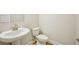 Simple powder room with a pedestal sink and toilet offers a minimalist and functional space at 4680 Hemingway Trl, Cumming, GA 30041