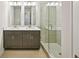 Bathroom with double sink vanity, granite countertop, and a glass-enclosed shower with tile surround at 4680 Hemingway Trl, Cumming, GA 30041