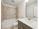 Modern bathroom features tile flooring and shower surround plus dark vanity with light countertop at 4680 Hemingway Trl, Cumming, GA 30041