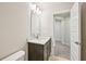 Bathroom with dark vanity and tile flooring leads into additional spaces at 4680 Hemingway Trl, Cumming, GA 30041