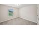 Clean bedroom with neutral walls and carpet features a double window with a pleasing view at 4680 Hemingway Trl, Cumming, GA 30041