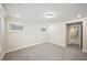 Spacious carpeted bedroom with windows offering natural light and a hallway view at 4680 Hemingway Trl, Cumming, GA 30041