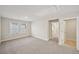 Bright bonus room features neutral walls and carpet and is accessible from multiple doorways at 4680 Hemingway Trl, Cumming, GA 30041