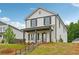 Charming two-story home with a covered front porch and neatly landscaped yard at 4680 Hemingway Trl, Cumming, GA 30041