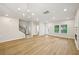 Spacious living room with hardwood floors, modern chandelier, and lots of natural light at 4680 Hemingway Trl, Cumming, GA 30041