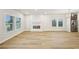Bright living room features hardwood floors, a fireplace, modern lighting, and windows offering an inviting space at 4680 Hemingway Trl, Cumming, GA 30041