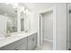 Bathroom featuring dual sinks, modern cabinets, and a glass-enclosed shower at 4690 Hemingway Trl, Cumming, GA 30041