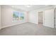 Bright, carpeted bedroom with natural light and an open closet at 4690 Hemingway Trl, Cumming, GA 30041