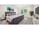 Staged bedroom showcases a cozy space with a large bed, stylish decor, and ample natural light at 4690 Hemingway Trl, Cumming, GA 30041