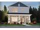 Charming two-story home featuring stone accents, a covered front porch, and a well-manicured lawn at 4690 Hemingway Trl, Cumming, GA 30041