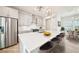 Modern kitchen with stainless steel appliances, island, and adjacent dining area, virtually staged at 4690 Hemingway Trl, Cumming, GA 30041