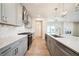 Spacious kitchen featuring stainless appliances, island, and seamless flow into the living area at 4690 Hemingway Trl, Cumming, GA 30041