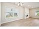 Open-concept living area with wood floors, modern fireplace, and large windows for natural light at 4690 Hemingway Trl, Cumming, GA 30041