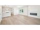 Inviting open-concept living space showcasing hardwood floors, modern kitchen, and a cozy fireplace at 4690 Hemingway Trl, Cumming, GA 30041