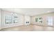 Bright living room features hardwood floors, modern fireplace, large windows, and glass door entrance at 4690 Hemingway Trl, Cumming, GA 30041