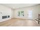 Modern living room features hardwood floors, fireplace, large windows, and a glass door entrance at 4690 Hemingway Trl, Cumming, GA 30041