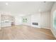 Bright and airy living room featuring hardwood floors, fireplace, and an open layout to the kitchen at 4690 Hemingway Trl, Cumming, GA 30041